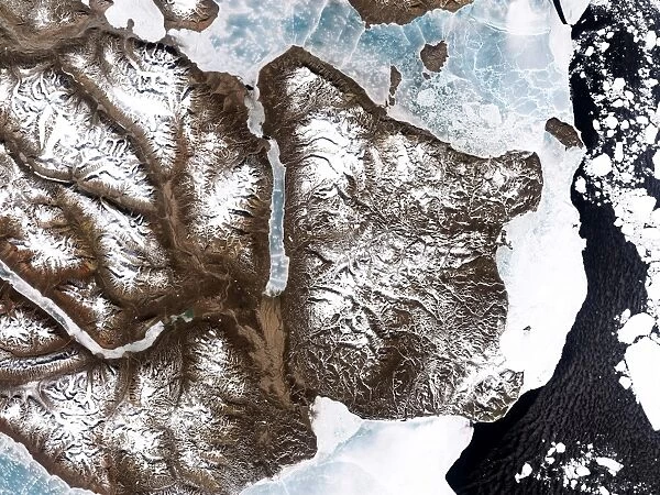 Sea ice lines the shoreline in eastern Greenland