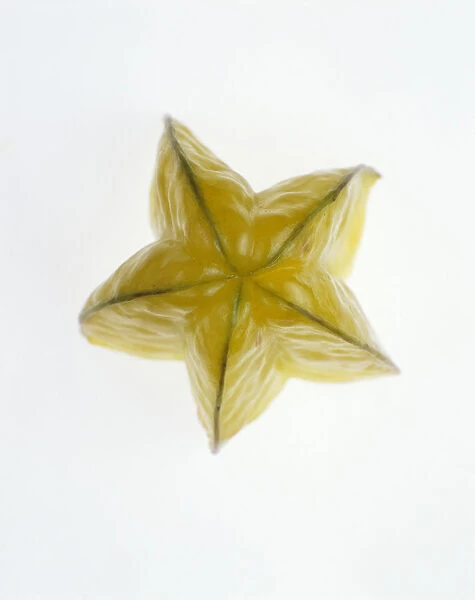 Starfruit. Studio shot of slice of Starfruit showing skin and ridged exterior form
