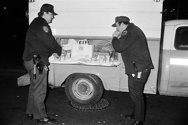 New York Police enjoying a Burger King meal from the side of a van. 13th February 1981