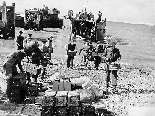 WW2 - Troops unload supplies from a landing craft on to British soil after a raid
