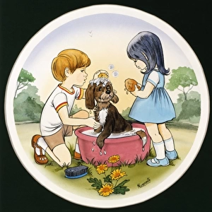 A boy and a girl wash their pet dog
