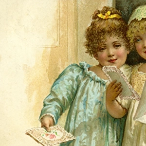 Two little girls receive a card