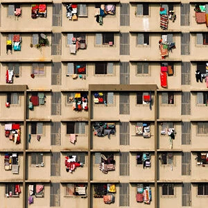 Laundry is seen hanging on the windows of a residential building in Mumbai