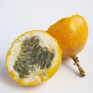 Passiflora edulis (Passion fruit) cross section showing seeds inside yellow fruit, close-up