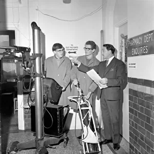 The two boys with Head Porter M. A. Giles moving some equipment at Out-Patients