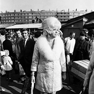 Diana Dors Actress walking throgh a busy market in Leeds Yorkshire Dbase MSI