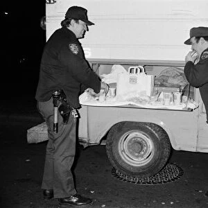 New York Police enjoying a Burger King meal from the side of a van. 13th February 1981